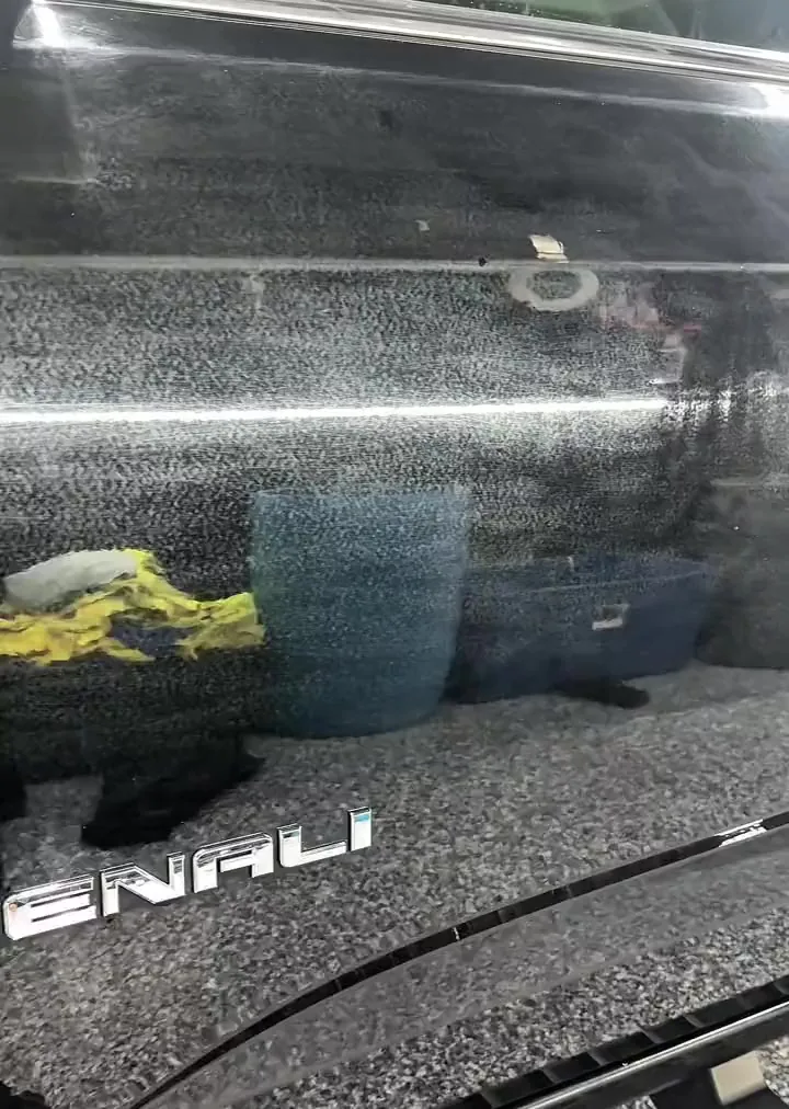 The polished door of a black GMC Denali in the studio