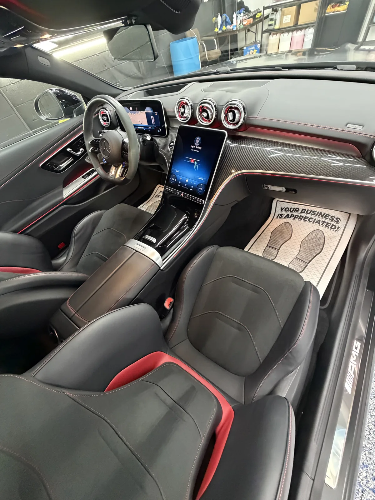 Mercedes front cabin with black and red seats and a wide screen