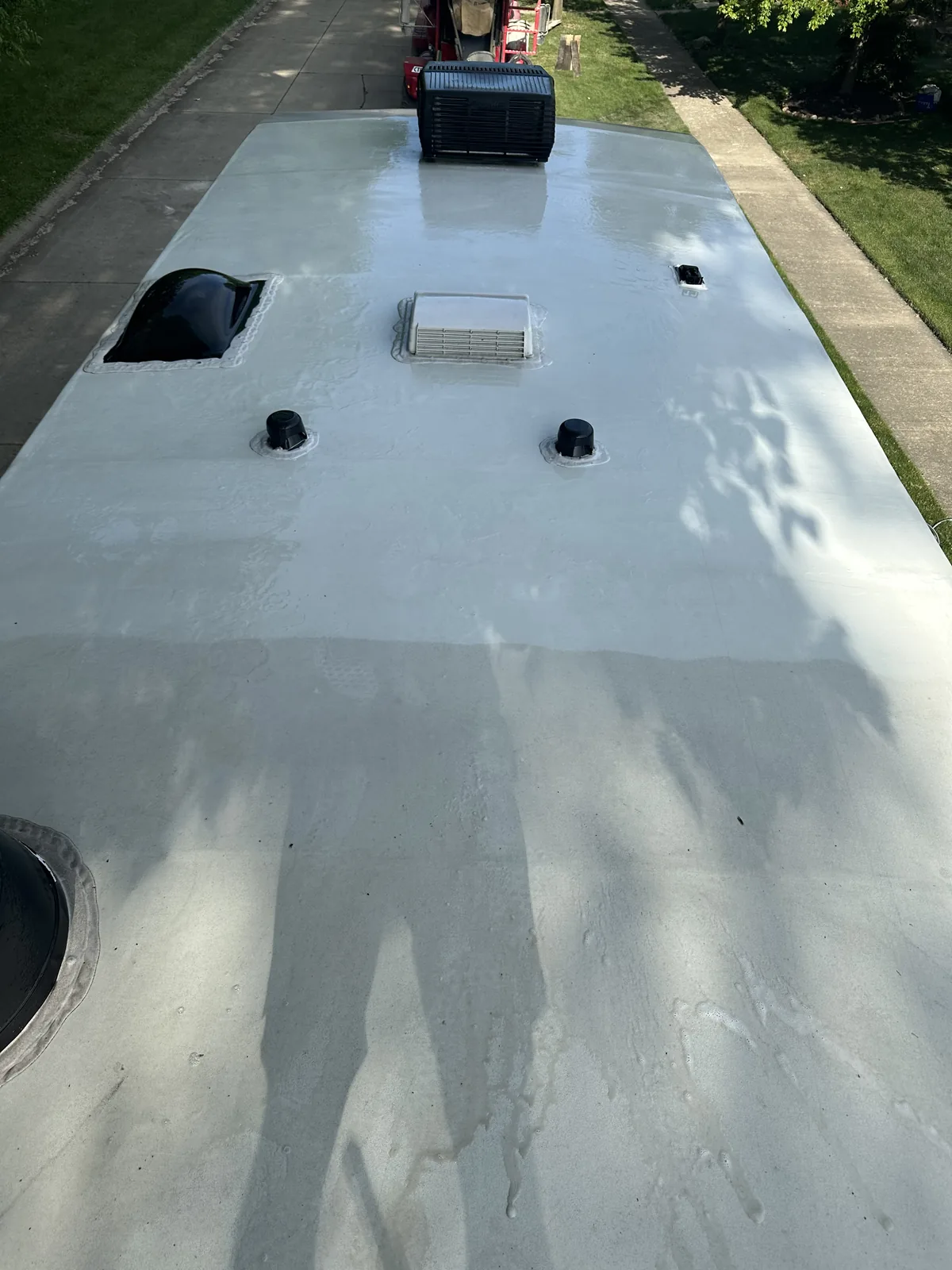 The roof of an RV, looking down from a ladder
