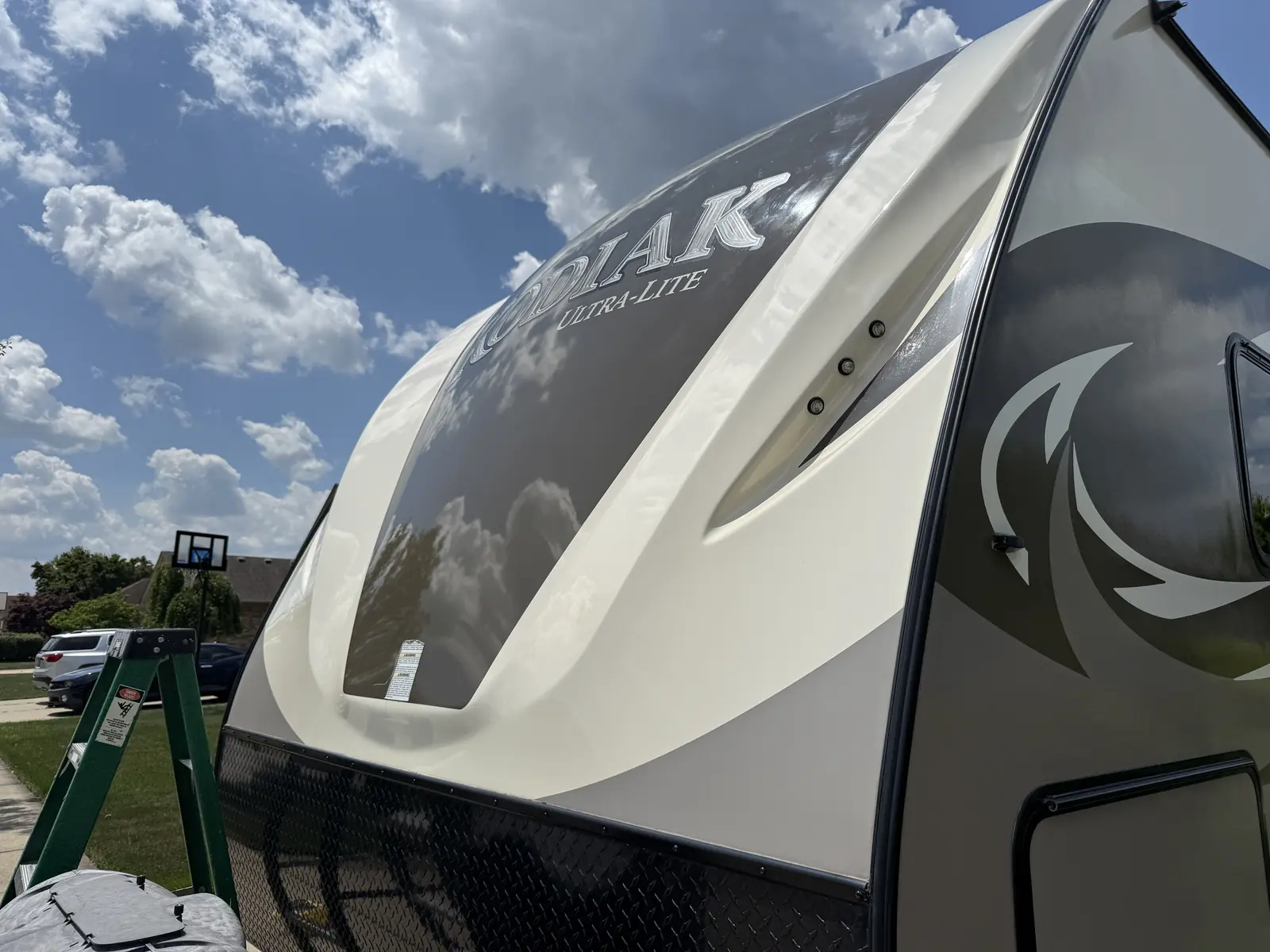 White and grey travel trailer RV under a bright sky