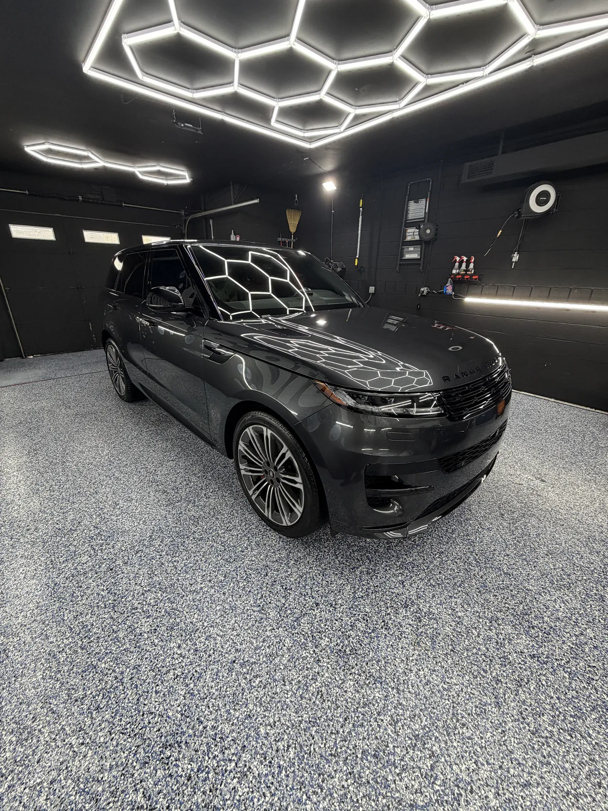 Black SUV under the hexagonal lights in the studio