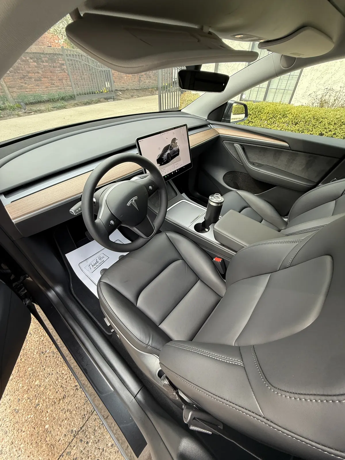 Tesla Model Y interior with black seats and floor mats