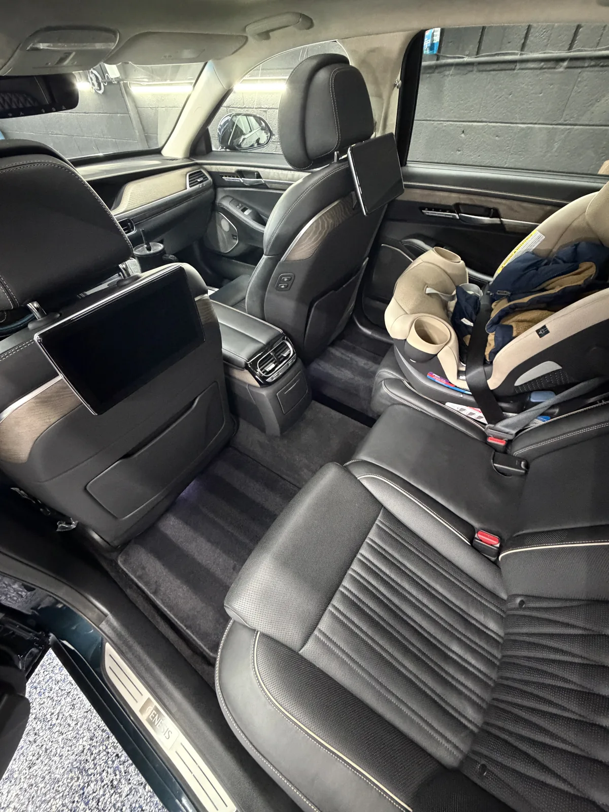 Pickup rear cabin with grey leather seats and a child seat